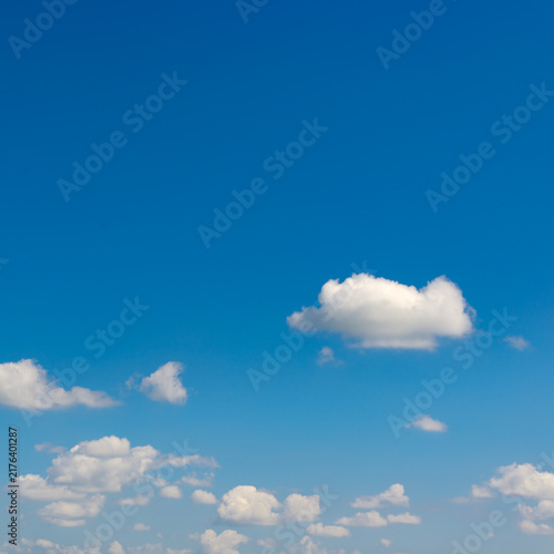 Serene sky view with soft cumulus clouds and vibrant blue background