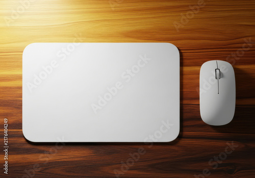 Blank white mouse pad and computer mouse on a rustic wooden desk surface