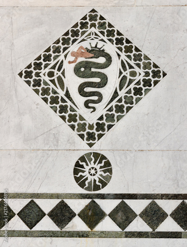 LUCCA, ITALY - JUNE 23, 2026: The detail of medieval marble intarsia  (snake) of church Cattedrale di San Martino by unknown artist (1210 – 1230).