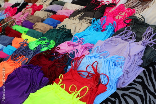 Fotografía Colorful tank tops and camisoles displayed on a market stall