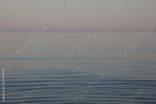 Принти на полотні Minimalist peaceful calm sea horizon with gentle ripples at sunrise