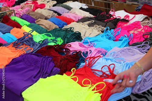 Colorful womens tank tops and camisoles displayed on a market stall table in Treporti Italy