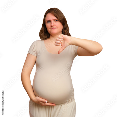 Fotografía Pregnant woman gesturing thumbs down showing disagreement or disapproval