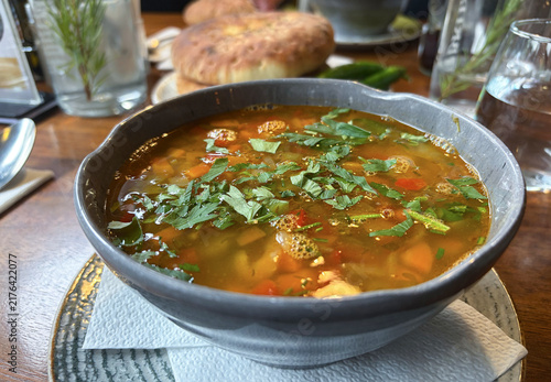 Konstfotografi Romanian Ciorbă with vegetables, legumes and smoked meat, served in a bowl