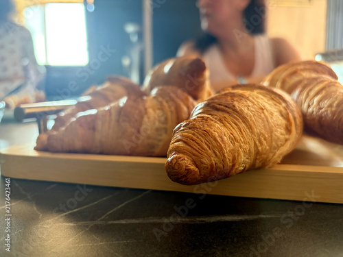 Warm croissants served on a wooden tray
