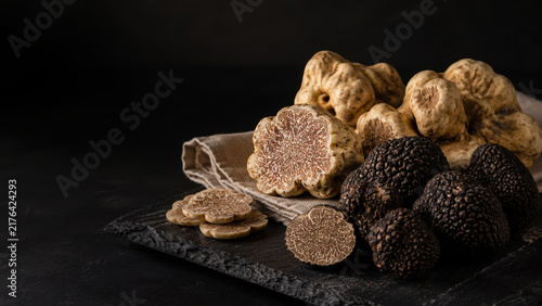 Black and White Truffles Displayed on Dark Rustic Background