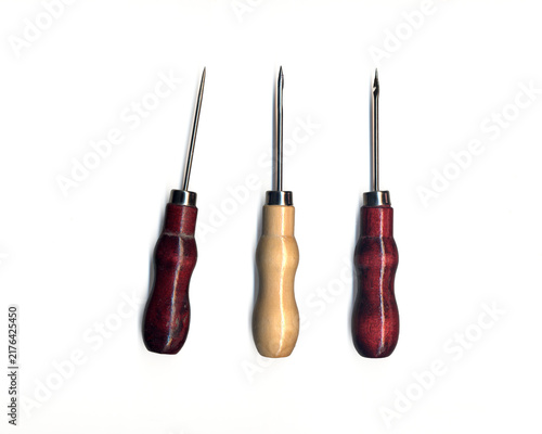 Obraz na plátne Three pointed metal awls with wooden handles on a transparent background