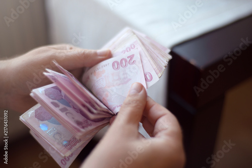 A person is counting paper money