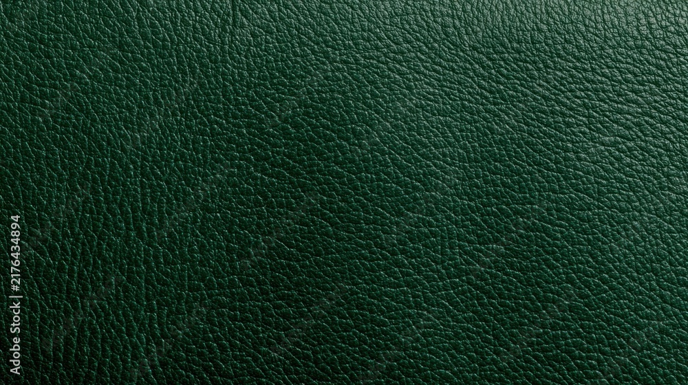 Obraz premium The emerald green leather texture displays a fine grain and rich saturation, providing a luxurious backdrop for design uses.