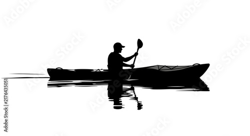 Silhouette of kayaker paddling on calm water with reflection