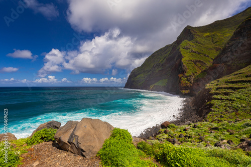 Coastal landscape with cliffs, beach and ocean under blue sky with clouds, Achadas da Cruz, Madeira