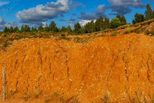 Fotografie Craggy clay mounds and eroded soil textures dominate the landscape at an abandon