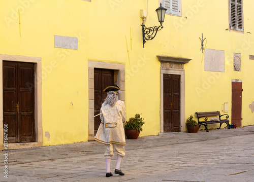 Man in 18th-Century Venetian Baroque Costume Walking in Historic European Square
