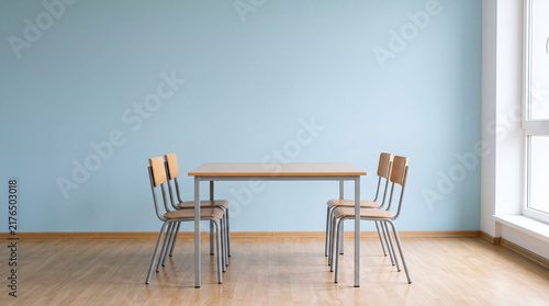 Modern Empty Classroom Table and Wooden Chairs Arranged in Bright Minimalist School Interior