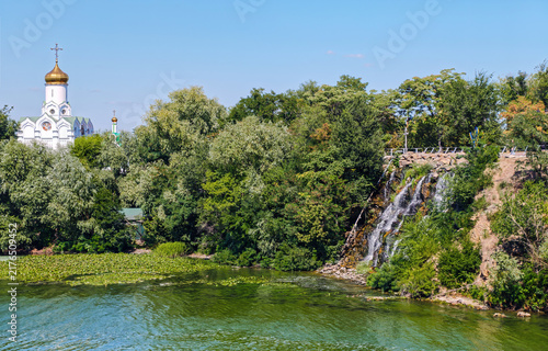 An artificial waterfall Porih revuchyi and church on Monastyrskyi Island in the Dnipro city