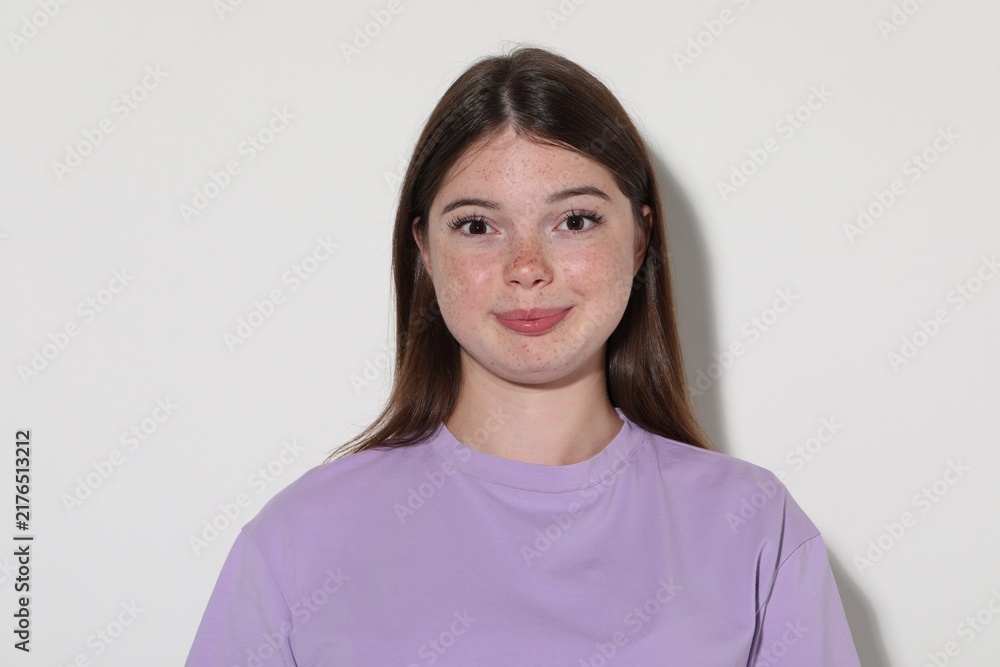 Fototapeta premium Beautiful teenage girl with freckles on white background