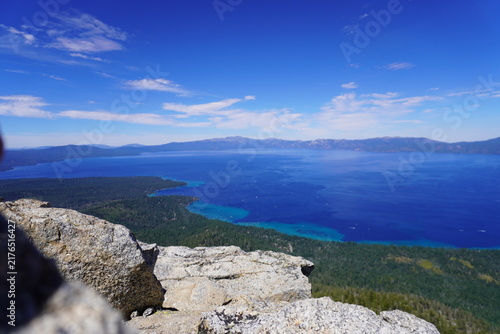 Obraz na płótnie Panoramic high angle view of deep blue water and emerald bay shoreline of Lake Tahoe looking down from rocky summit cliff under a clear blue sky