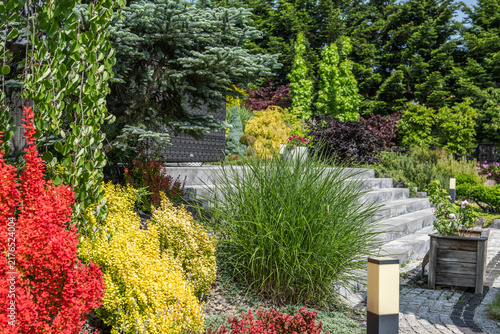 Stone garden steps framed by ornamental shrubs and grasses