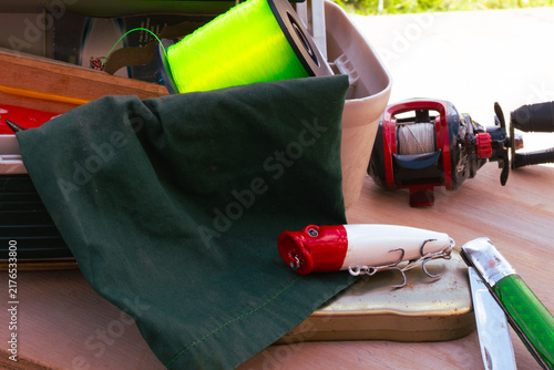 Quadro su tela Fishing equipment on a wooden surface