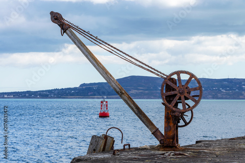Bild auf Leinwand Old rusty winch crane at end of Great South Wall