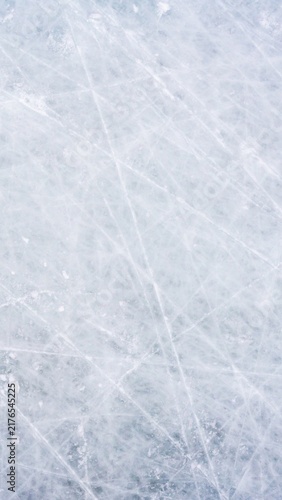 Obraz na plátně Ice background with marks from skating and hockey, blue texture of rink surface