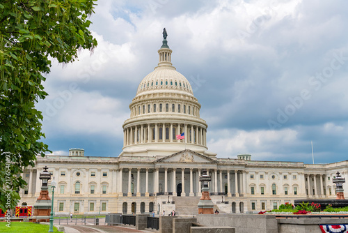 Neoclassical Capitol building appears across landscaped public grounds on Capitol Hill.