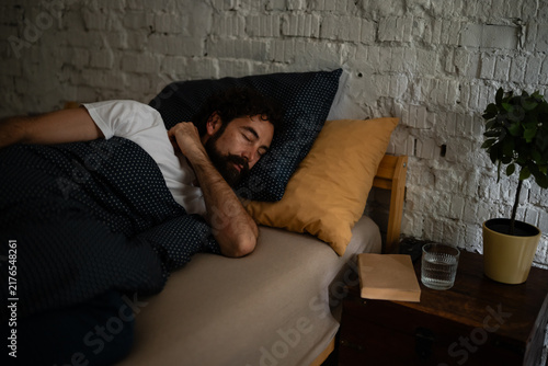 Obraz na płótnie Man sleeping in bed at home for rest and relaxation