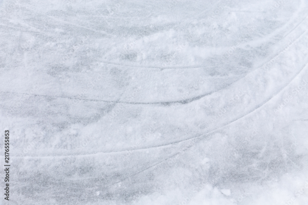 Obraz premium Ice background with marks from skating and hockey, blue texture of rink surface with many scratches