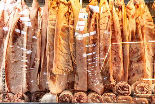 Fresh cuts of raw pork  arranged in a refrigerated display case at a butcher shop or supermarket, ready for sale.. Sao Paulo city, Brazil