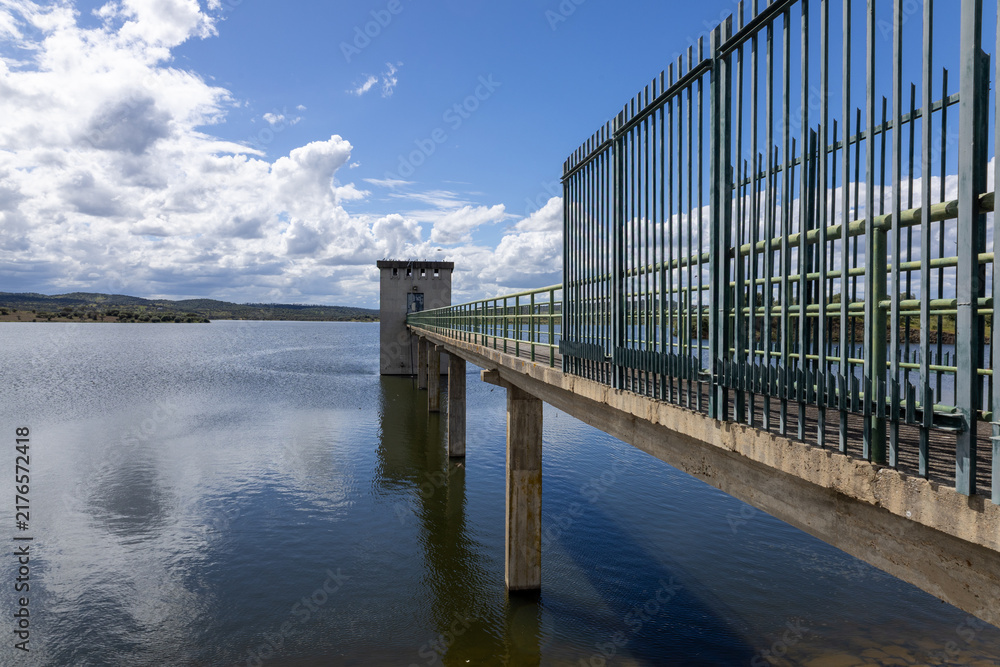Naklejka premium Dam intake tower and bridge over alentejo lake
