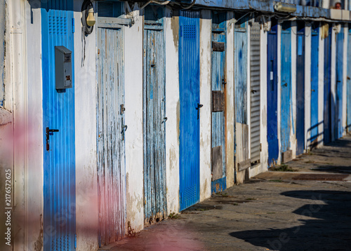 Canvastavla Weathered blue wooden doors on fisherman sheds in the old port of Sanremo, Italy