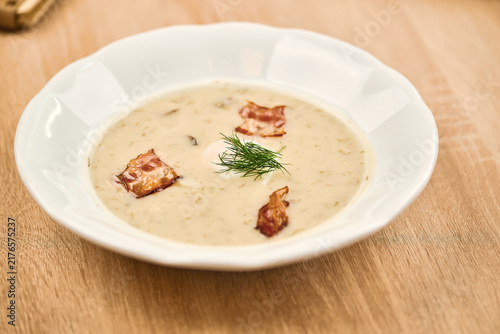 Konstfotografi Creamy soup with bacon pieces and fresh dill in a white bowl