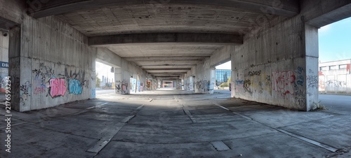 Urban Underpass - Concrete Structure with Graffiti and Natural Light.