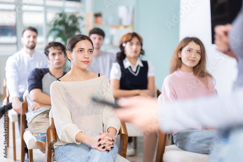Students are in a foreign language speaking club, they practice speaking. Young women and men receive additional education in an educational institution
