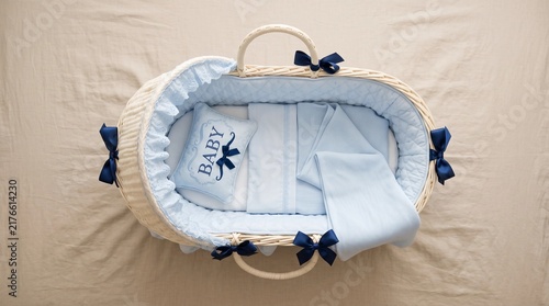 Top View of Empty Baby Moses Basket Bassinet with Light Blue Bedding and Pillows