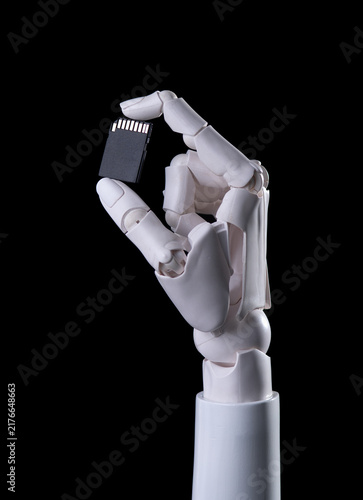 Robotic Hand Holding SD Memory Card Isolated on Black Background