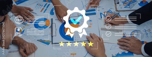 Obraz na plátně A collaborative meeting scene featuring hands over charts and graphs, with symbols of quality and certification, representing teamwork and strategic planning in a modern office setting
