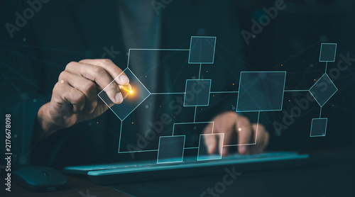Businessman drawing virtual flowchart diagram and process management structure with stylus pen, workflow organization and system planning concept.