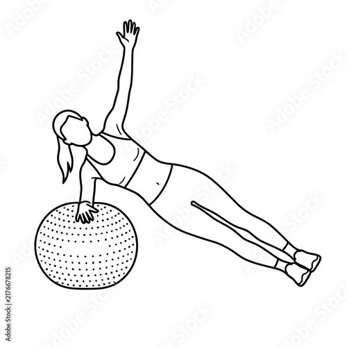 Woman doing side plank exercise with fitness ball