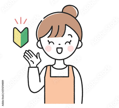 初心者マークと笑顔で案内をする主婦