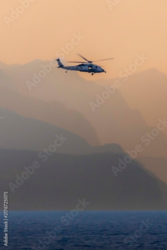 Canvastavla helicopter in the sky at sunset