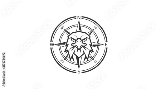 Black and white vintage style compass rose illustration with a fierce eagle head design in the center of the dial.