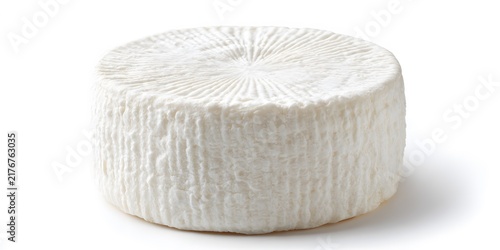 Round wheel of white soft cheese with textured bloomy rind isolated on a plain background
