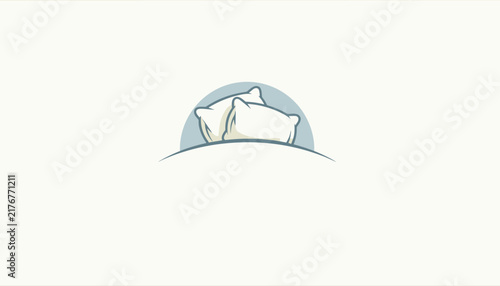 Two fluffy white pillows on a bed showcasing comfort and relaxation for a peaceful night of deep healthy sleep.
