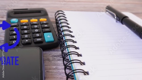 Notebook, pen, calculator, and phone on wooden surface