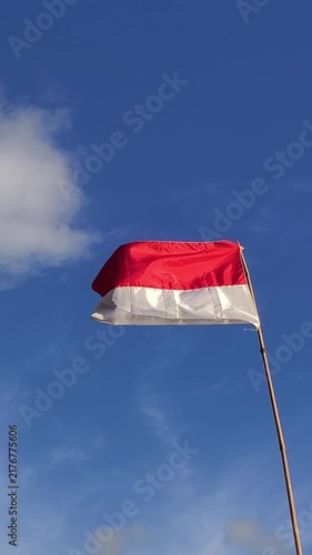 waving flag of Indonesia against blue sky, part 4