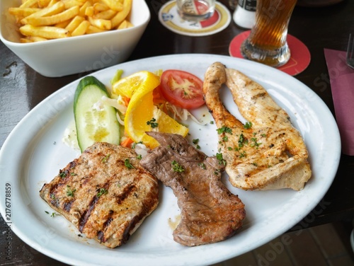 Obraz na płótnie Grilled meat steak and chicken fillet with salad and french fries