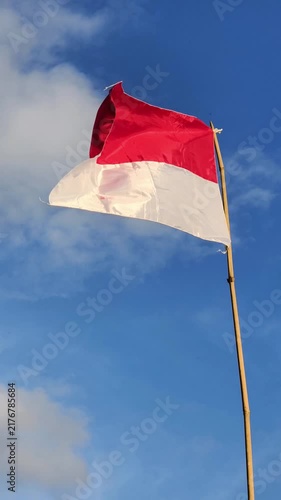 waving flag of Indonesia against blue sky, part 1