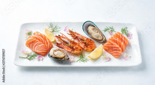Elegant seafood platter with salmon sashimi grilled shrimp and mussels on white plate