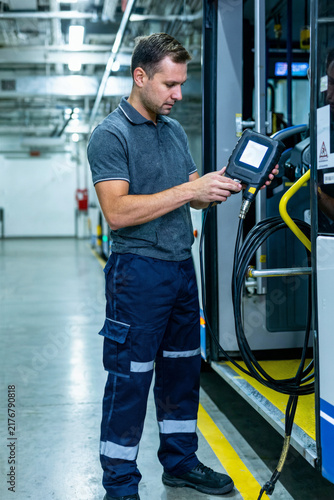 Naklejka Electric Bus Technician Performing Cable Insulation Test